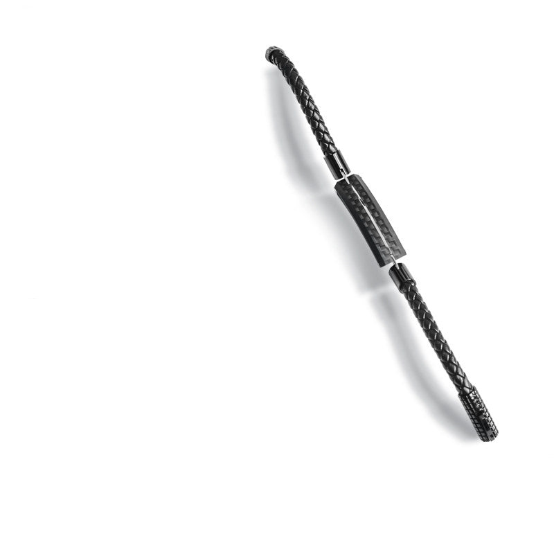 Close-up detail of a carbon fiber bracelet featuring a black braided strap and metallic accents.