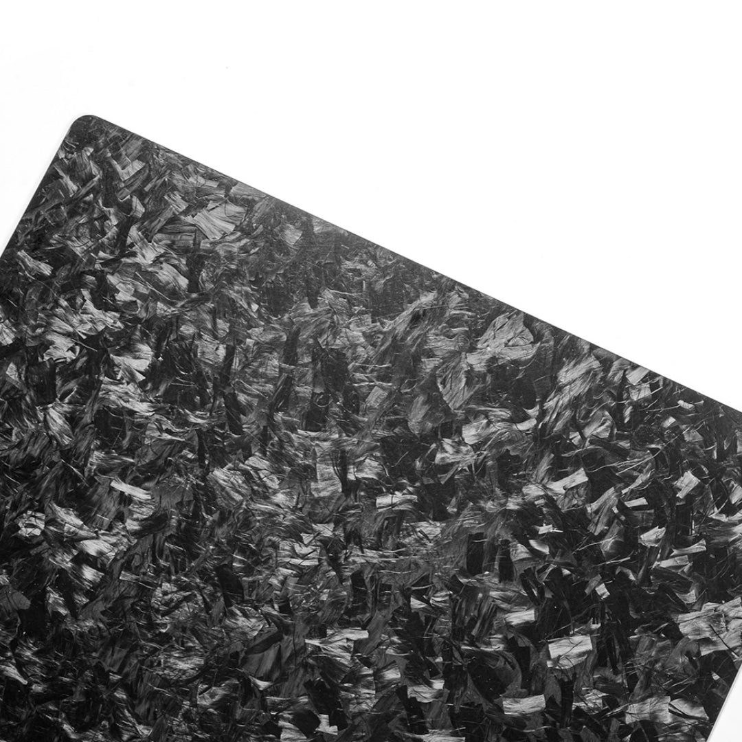 Close-up detail of a forged carbon fiber clipboard showcasing its distinct chopped texture against a white background.