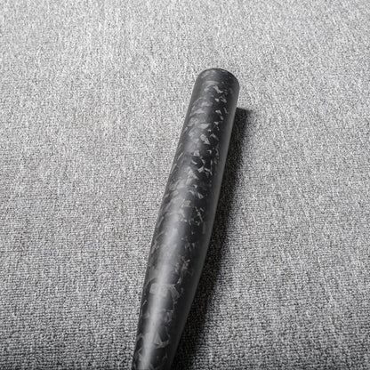 Close-up of a forged carbon fiber baseball bat showcasing the distinct chopped carbon fiber pattern, placed on a gray textured fabric surface.