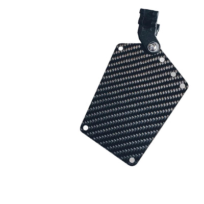 Close-up of a carbon fiber bicycle number plate with a distinct woven pattern, featuring a mounting clip.