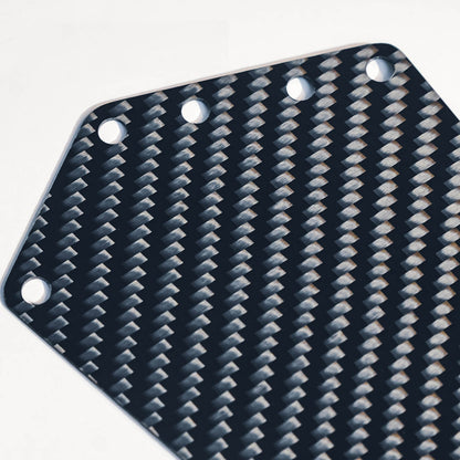 Close-up of a carbon fiber bicycle number plate showcasing its distinct woven pattern and mounting holes.