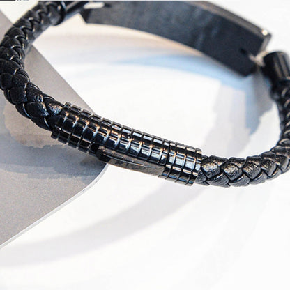 Close-up detail of a carbon fiber bracelet with a black braided strap and metallic carbon fiber accents, placed on a light-colored surface.
