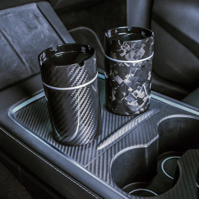 Close-up of two carbon fiber car ashtrays-one with a 3K carbon fiber pattern
