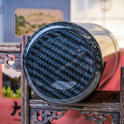 Close-up of the bottom of a 3K carbon fiber car ashtray, showcasing its distinct woven pattern, placed on traditional Chinese wooden craftsmanship.
