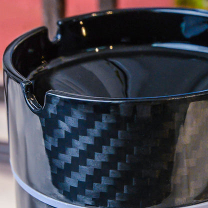 Close-up detail of a 3K carbon fiber car ashtray, showcasing its distinct woven pattern and glossy surface.