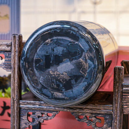 Close-up of the bottom of a forged carbon fiber car ashtray, showcasing its distinct fragmented pattern, placed on traditional Chinese wooden craftsmanship.