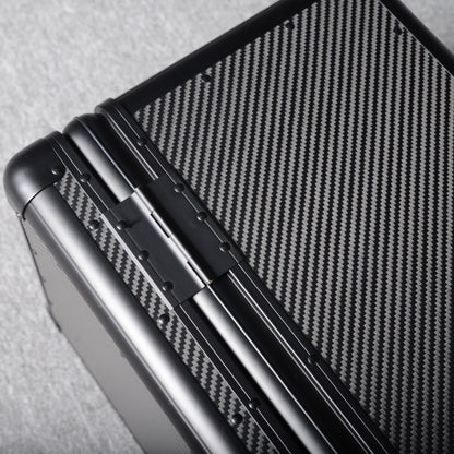 Close-up detail of a 3K carbon fiber large car storage trunk, showcasing the hinge and distinctive woven pattern, placed on a gray textured surface.