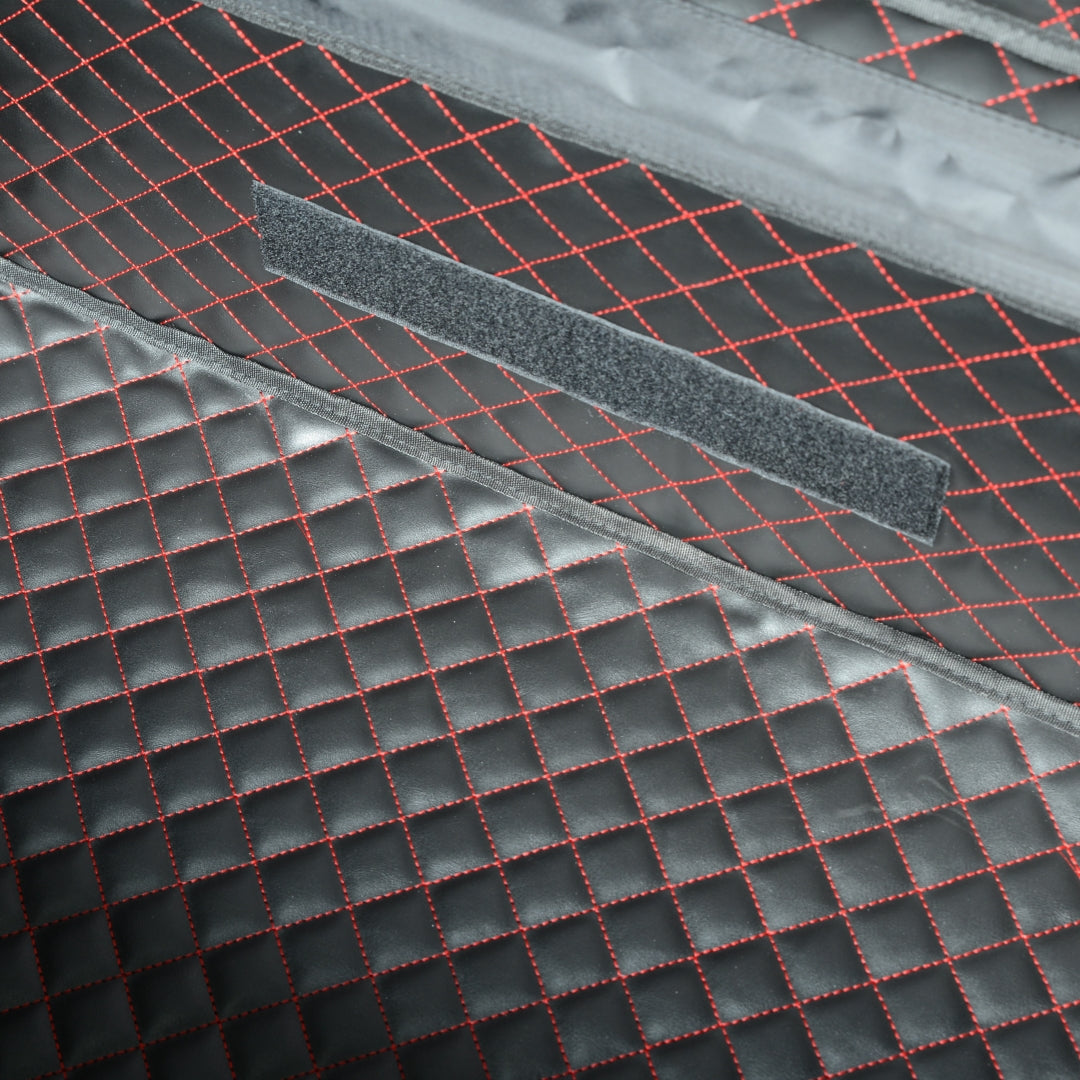 Close-up detail of the interior of a 3K carbon fiber large car storage trunk, featuring a quilted design with red stitching and a Velcro strip.