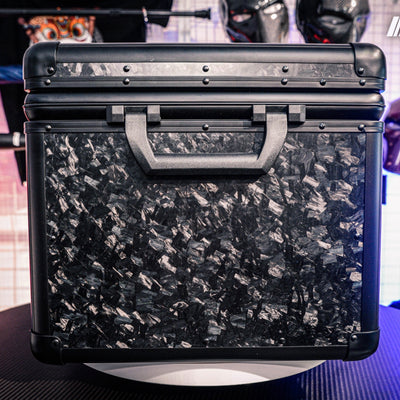 Close-up side view of a large forged carbon fiber car storage trunk, showcasing the chopped carbon fiber pattern and black handle