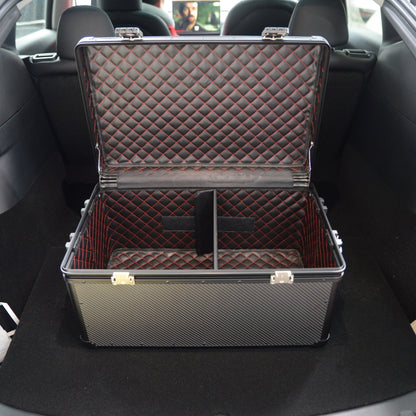 Close-up of an open 3K carbon fiber large car storage trunk with a quilted interior featuring red stitching and dividers, placed in a car trunk.
