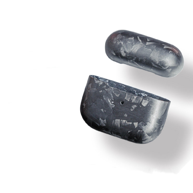 Close-up of forged carbon fiber AirPods cases showcasing the unique marbled texture.