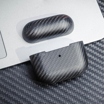 Close-up of 3K carbon fiber AirPods cases showcasing the distinct weave pattern