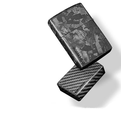 A close-up shot reveals the casing of a Zippo lighter in its closed state, crafted from forged carbon fiber and 3K carbon fiber.