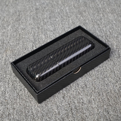 Close-up of a carbon fiber cigar case with a capacity for 2 cigars, featuring a distinct woven pattern, placed in an open black box with foam lining on a gray fabric surface.