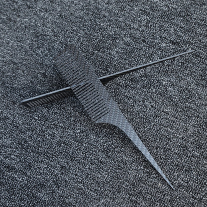 Close-up of carbon fiber combs with a distinct woven pattern, placed on a dark gray textured fabric surface.