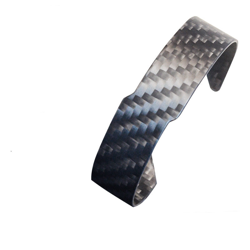 A 3K carbon fiber cuff bracelet with a distinct weave pattern.