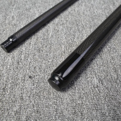 Two-piece carbon fiber pool cue with a textured carbon fiber pattern, placed on a gray textured surface.