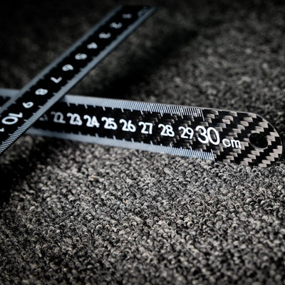 Close-up of two 3K carbon fiber rulers