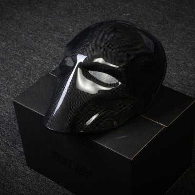Close-up of a black 3K plain weave carbon fiber tactical mask with a glossy finish and mesh eye openings