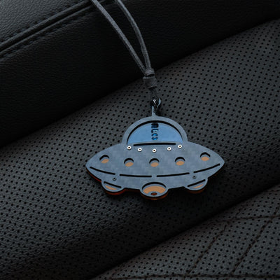 UFO-shaped accessory with a gray carbon fiber-textured body: It features a glossy blue cockpit section