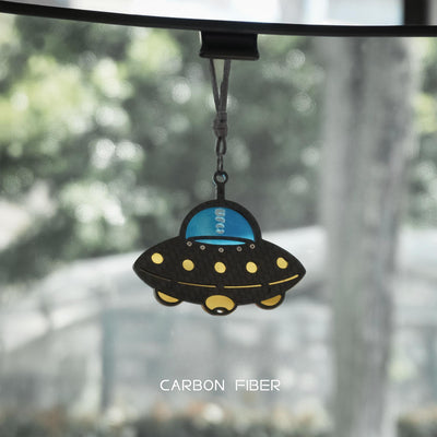 UFO-themed carbon fiber car pendant: Features a black carbon fiber-weave body, a glossy bright blue cockpit section (with "UFO" detailing)
